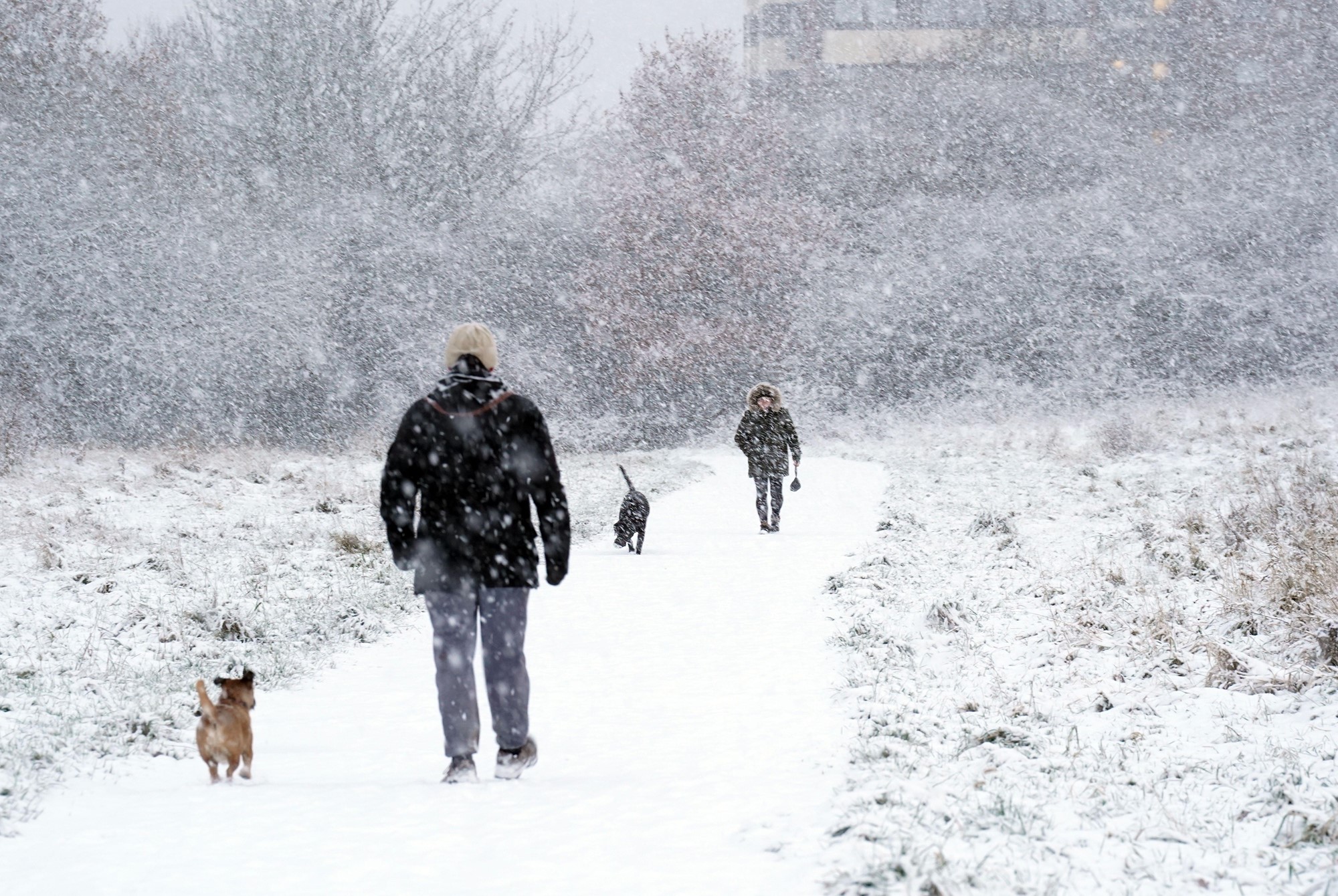 People in the snow in Gateshead. A yellow weather warning for snow and ice will remain in place on Friday for the eastern coast of the the UK, stretching from Scotland to East Anglia. Ice warnings remain in place for Northern Ireland and south-west England