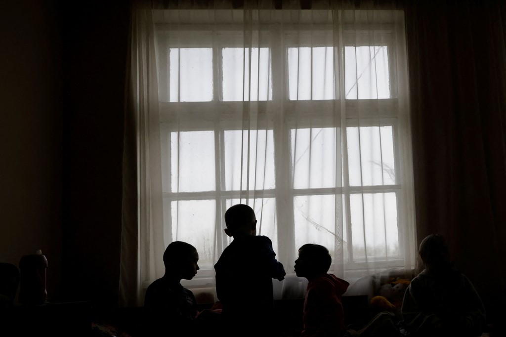 Ukrainian children gather at a shelter for refugees, waiting for a new life