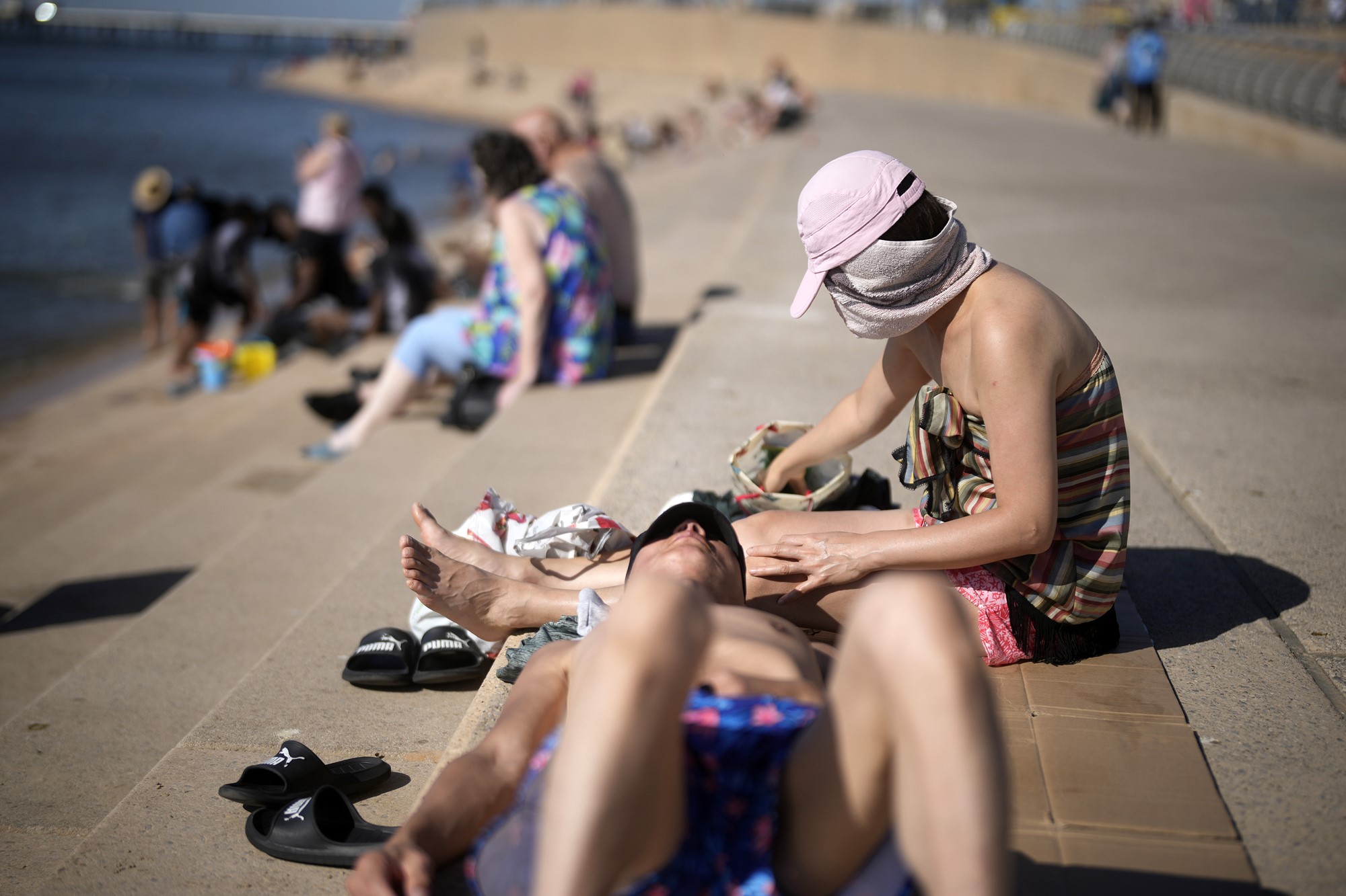 People enjoy the sunshine and high temperatures on Blackpool beach