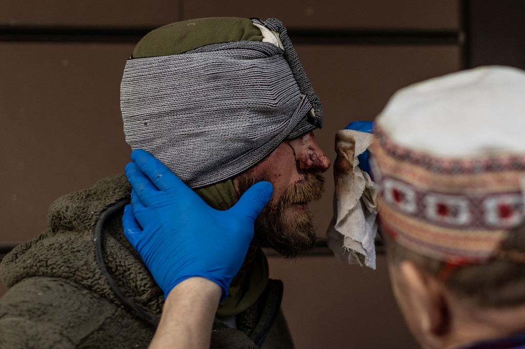 A nurse treats a soldier at the hospital