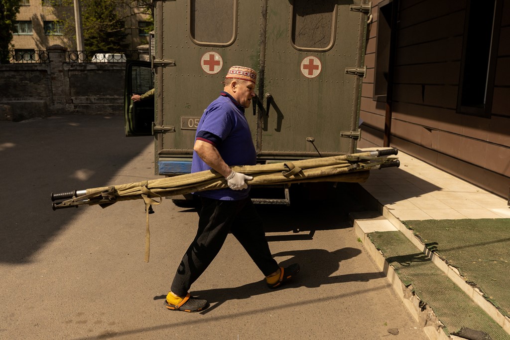 A nurse carries a stretcher at the hospital